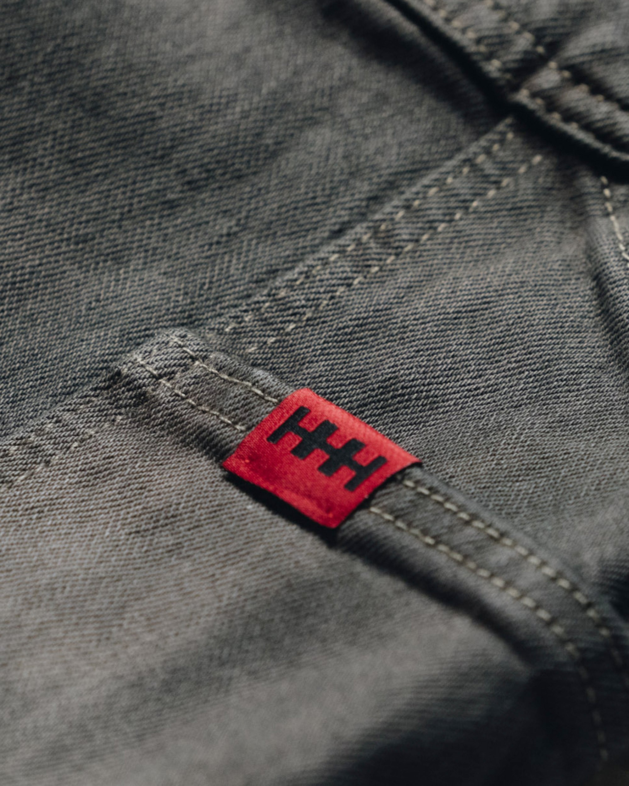 Red label with black text on a gray fabric background