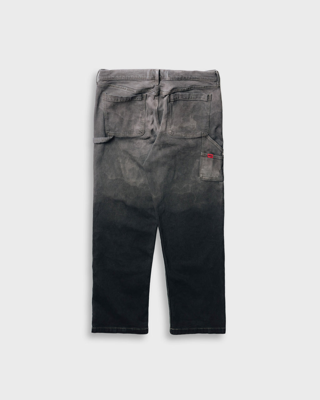 Black distressed jeans on a light gray background