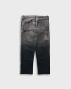 Black distressed jeans on a light gray background